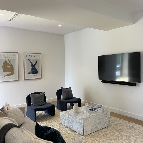 Flat-screen TV wall mounted on drywall in residential home