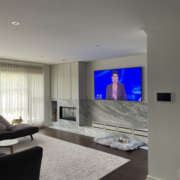 Flat-screen TV mounted on drywall in residential home