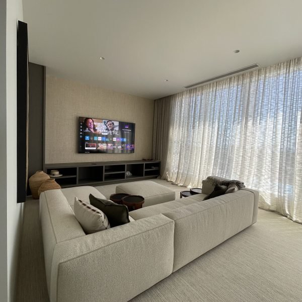 Flat-screen TV mounted on drywall in residential home