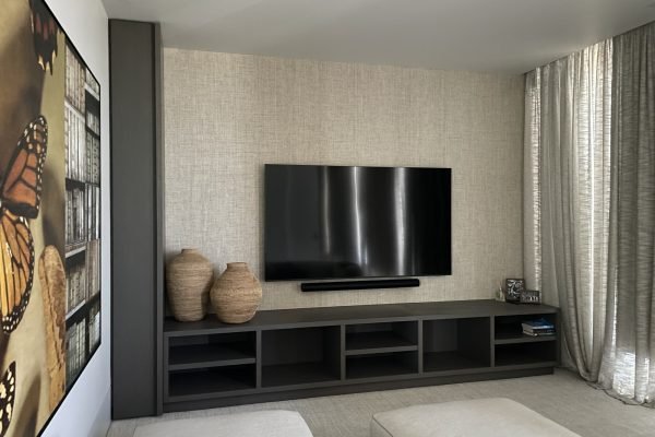 Flat-screen TV mounted on drywall in residential home