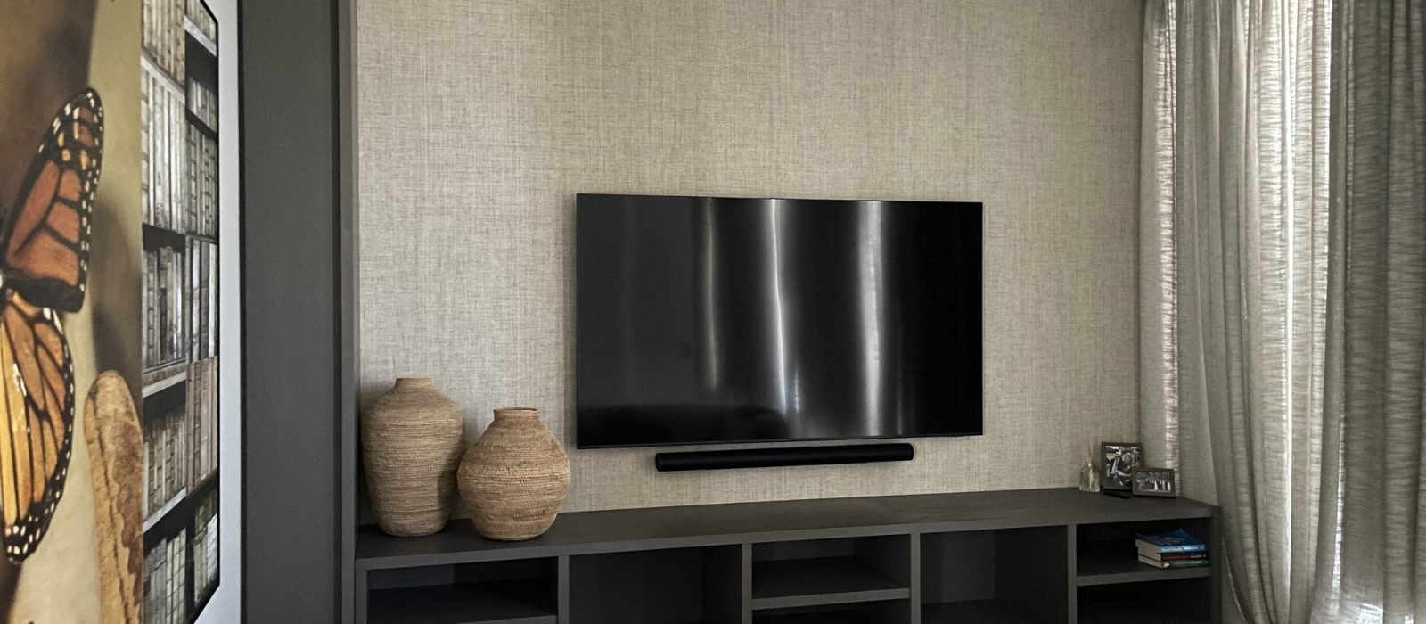 Flat-screen TV mounted on drywall in residential home