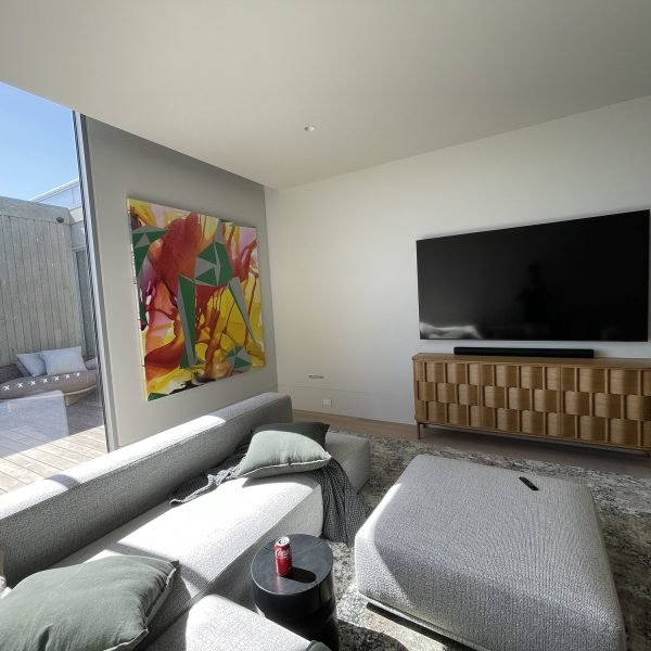 Flat-screen TV mounted on drywall in residential home